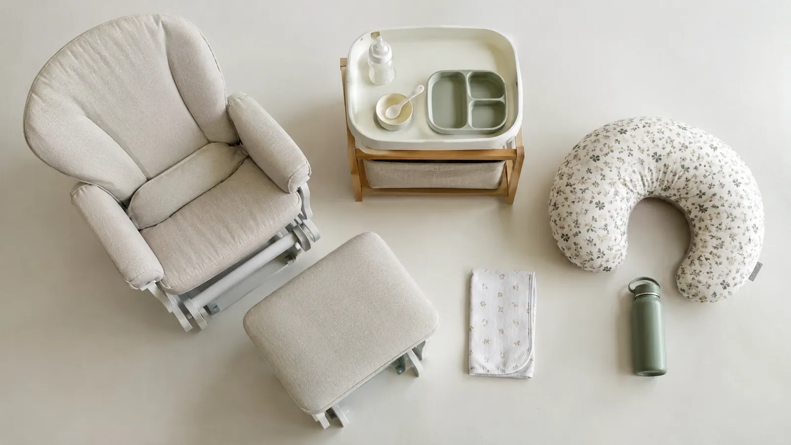 A simple diagram showing a feeding station setup: chair, footrest, water bottle, burp cloth, and nursing pillow